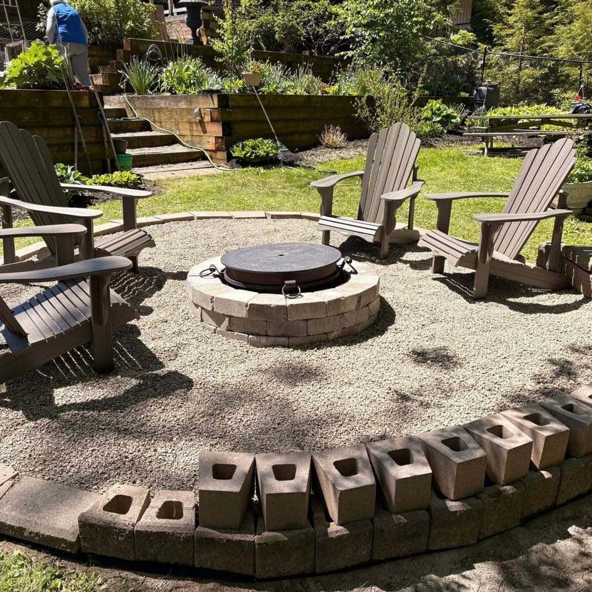 Finished backyard fire pit with Adirondack chairs built by Next Door Landscapers